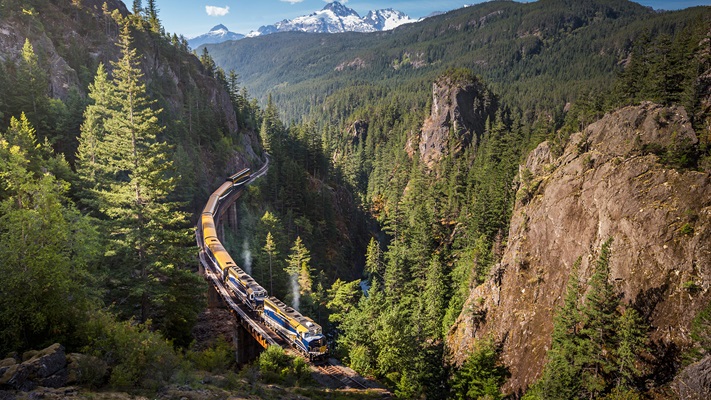 Mountainous pine forest with travel travelling through valley, Canda